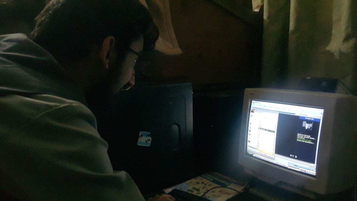 Person using an old computer with a CRT monitor